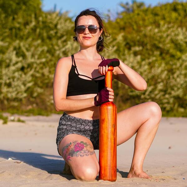 A female fitness enthusiast with Mudgar-Mudgar in India-The Great Indian Workout-Mudgar Club-SatvaFit-Tagda Raho Sports-Mudgar Market in India--Indian Fitness Tools-Traditional Indian Fitness Tools