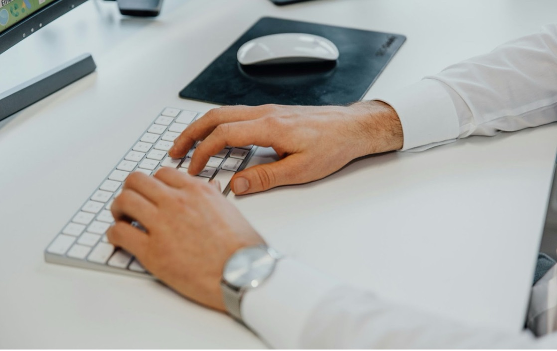a man typing something on his system 1