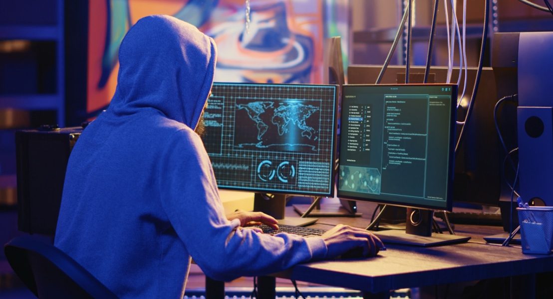 a person working on the system with multiple screens like coding 1