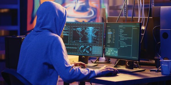 a person working on the system with multiple screens like coding 1